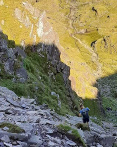 Young man hiking in the rocky mountains