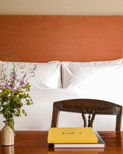 Bedroom with double bed and orange headboard