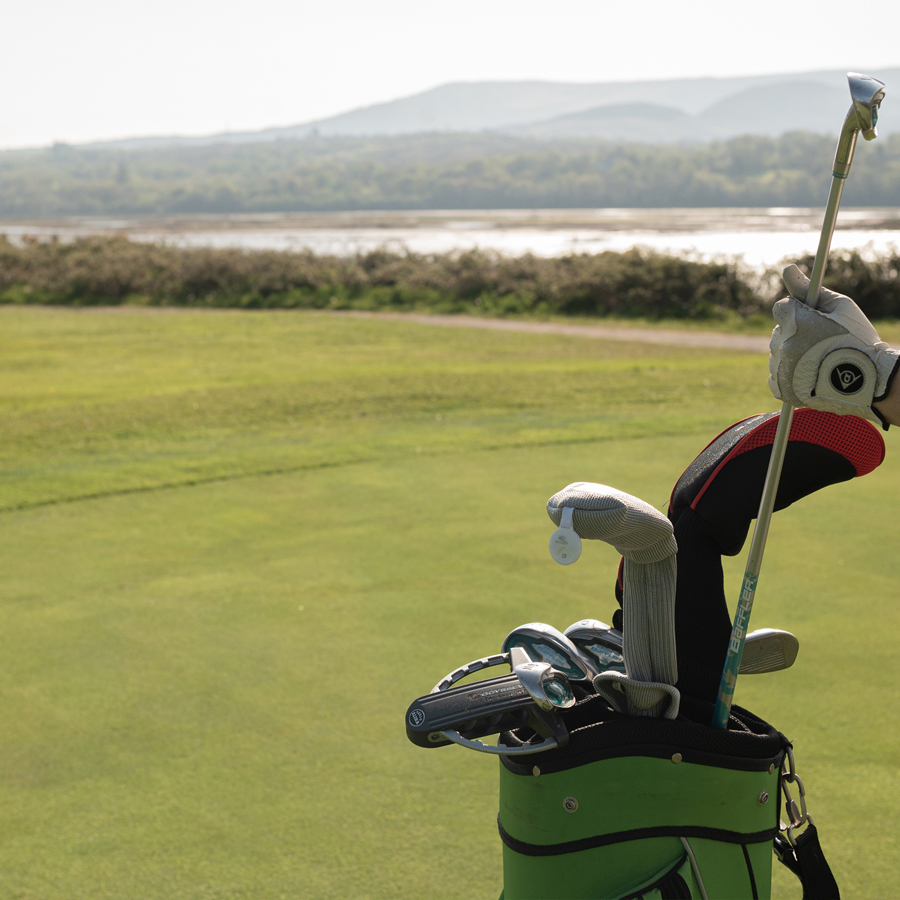 Golfer pulling out clubs at the field